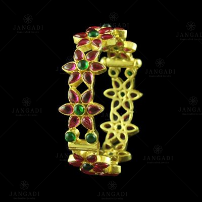 GOLD PLATED RED AND GREEN CORUNDUM FLORAL BANGLE