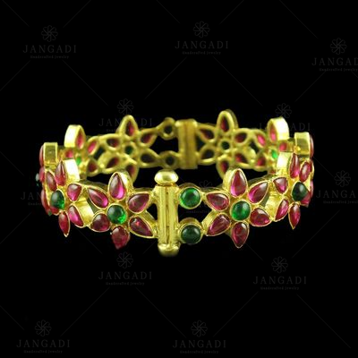 GOLD PLATED RED AND GREEN CORUNDUM FLORAL BANGLE